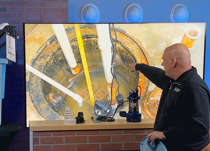 Shawn showing the inside of a sump pump