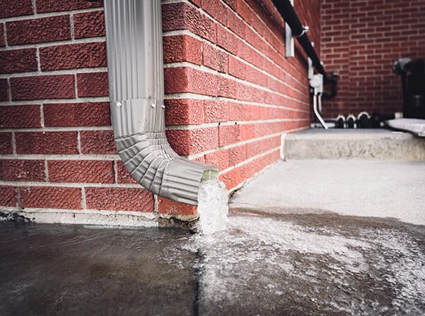 gutter draining a ton of water and damaging a sidewalk