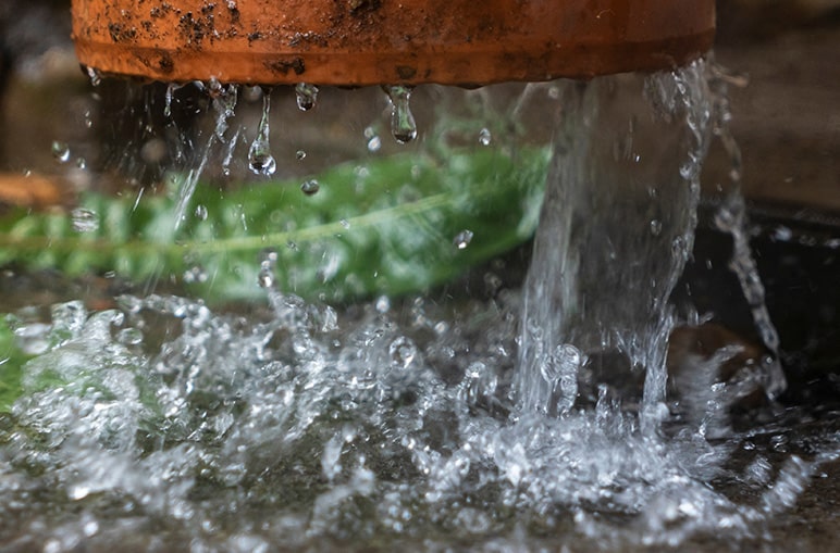 running water falling from pipe onto surface