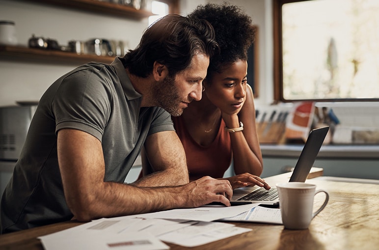 couple looking at computer at table