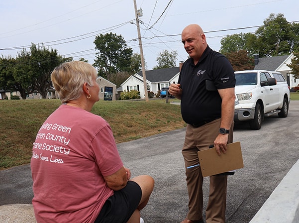 man talking to woman outside