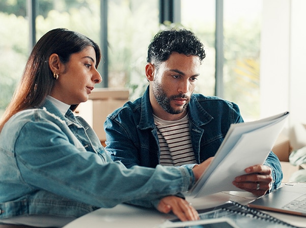 man and woman looking at paper