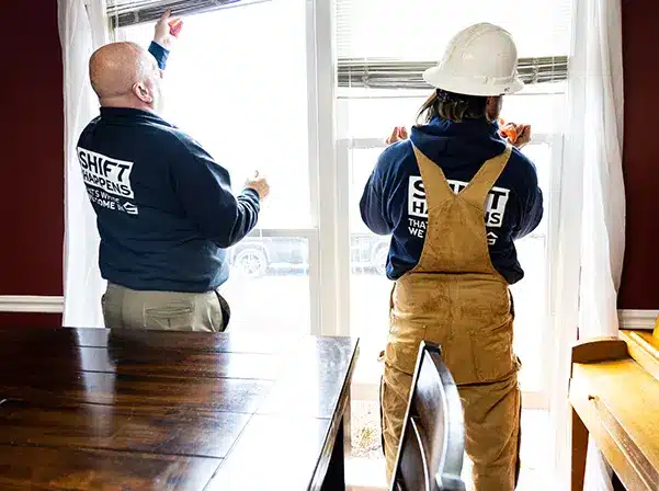 two people working on windows