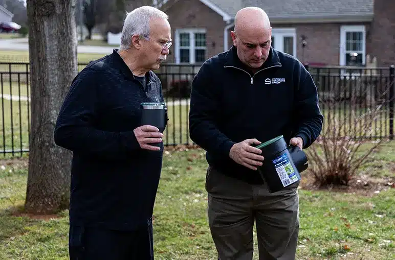 two men looking at something outside